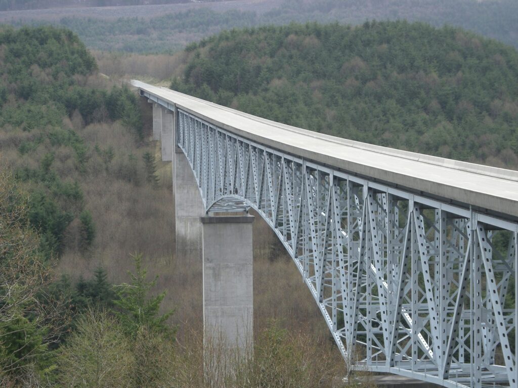 Long bridge spanning a valley, symbolizing how bridge loans connect selling an old home to buying a new one in Colorado.