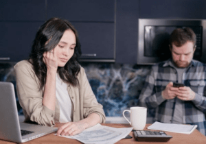 An image of a stressed woman looking at some documents