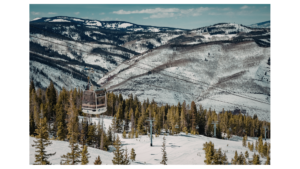 Gondola traveling over a snowy Colorado ski mountain representing seasonal income and a non-qm bank statement loan.