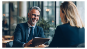 Mortgage broker smiling, talking to a client about Non-QM loan options and the Ability-to-Repay (ATR) Rule.